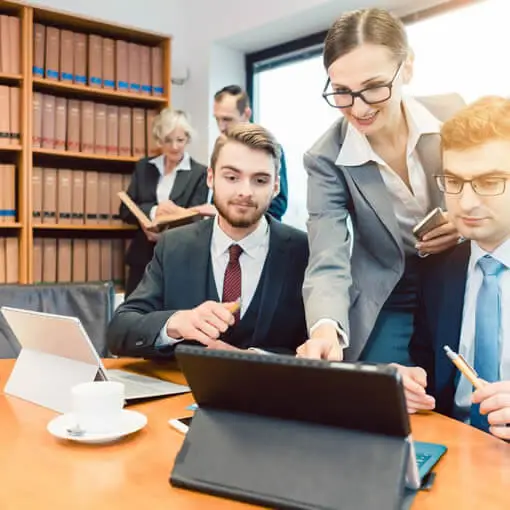 Law firm staffers looking at a laptop; Law firm digital marketing in Cleveland, Ohio and surrounding communities